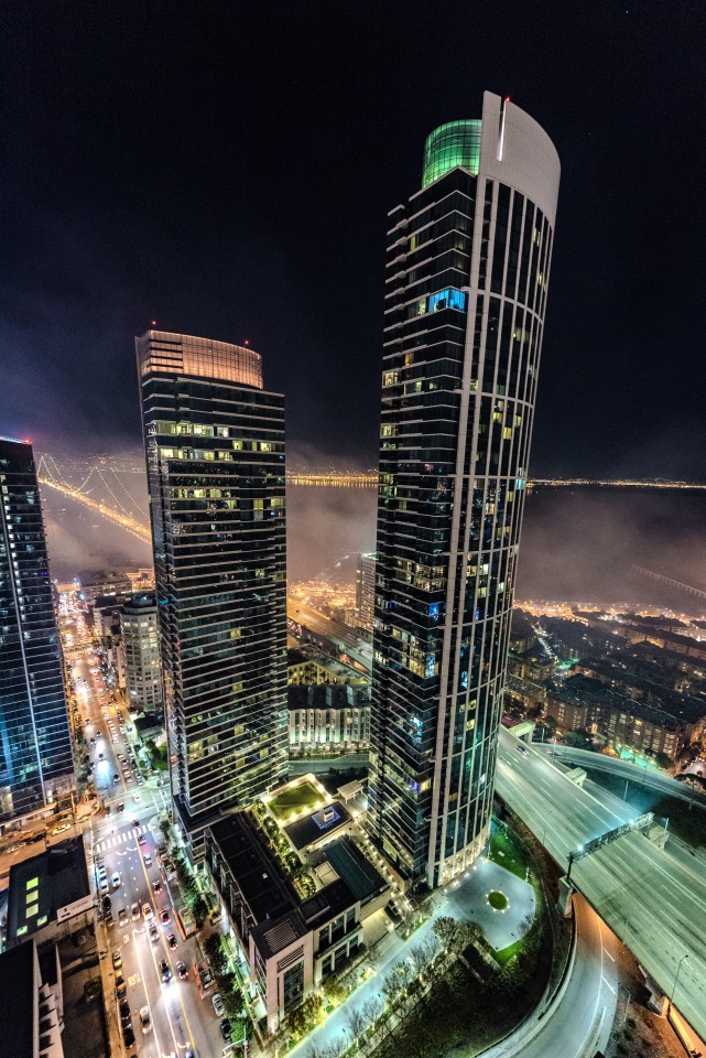 A modern city skyline of lit skyscrapers at night